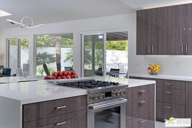 a kitchen with a stove a sink and a window