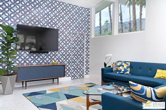 a living room with furniture and a potted plant