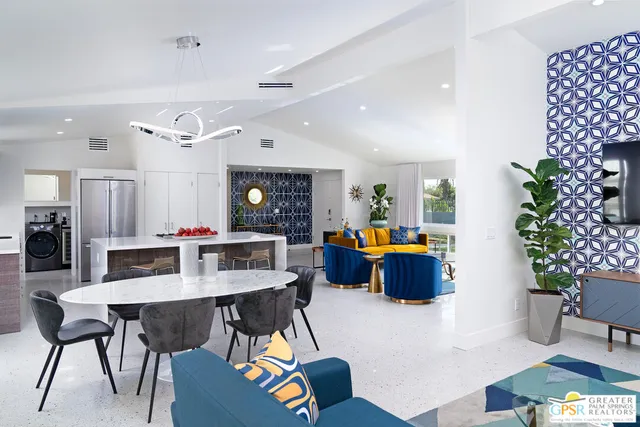 a living room with furniture and a dining table with kitchen view