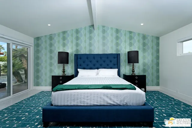 a bedroom with a bed and a night stand