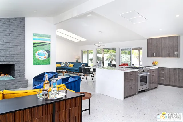 a kitchen with a stove a refrigerator and a dining table with wooden floor