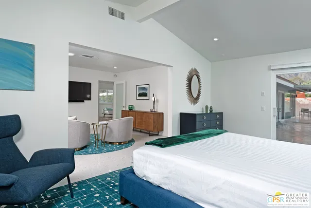 a living room with furniture a large window and a flat screen tv