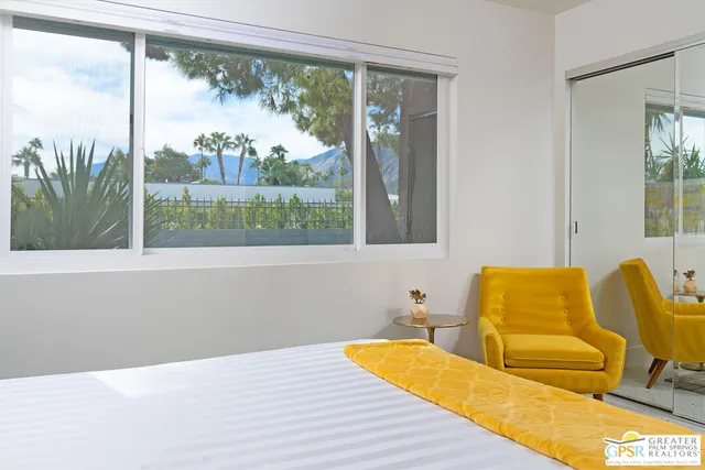 a blue bed sitting in a bedroom next to a window