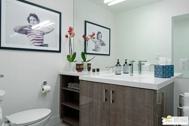 a bathroom with a sink mirror and toilet