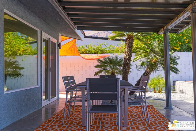 a view of a backyard with plants and a patio
