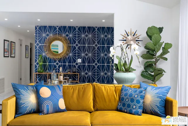 a living room with furniture and a potted plant