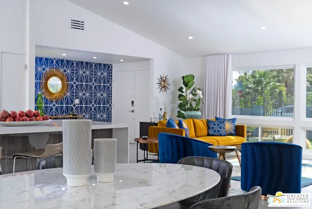 a living room filled with furniture and a large window