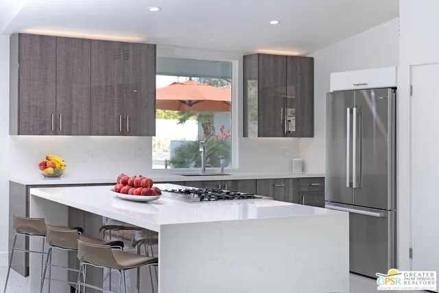 a kitchen with stainless steel appliances a refrigerator and a stove