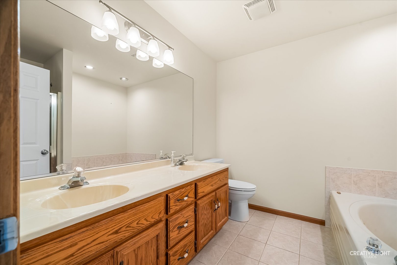 714 East Knights Road Sandwich, IL 60548 - Photo 12 of 33 a bathroom with a double vanity sink mirror and toilet