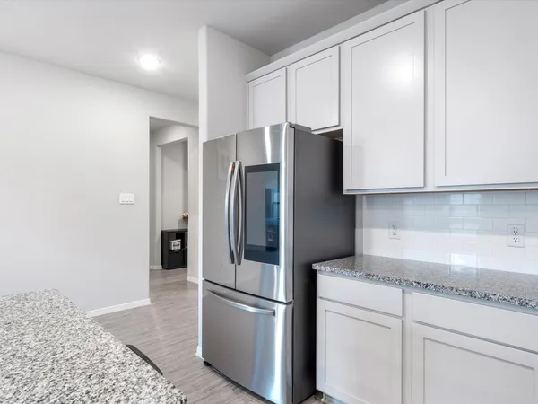 a kitchen with stainless steel appliances a microwave a sink a stove a table and chairs