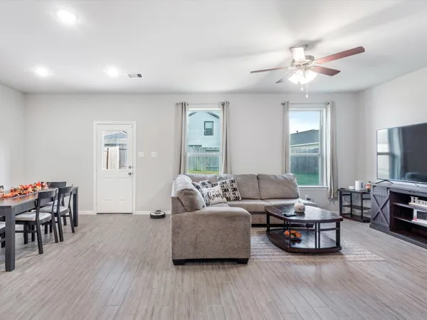 a living room kitchen with furniture and a dining table with kitchen view