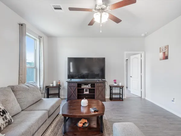 a living room with furniture kitchen and a table