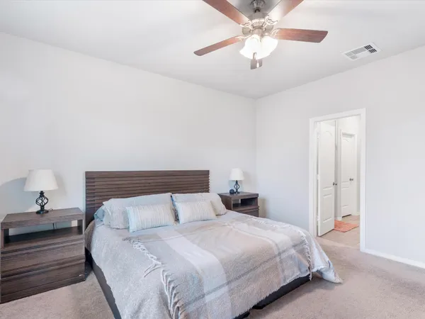 a bedroom with a bed and cabinets