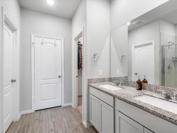 a bathroom with a glass shower door