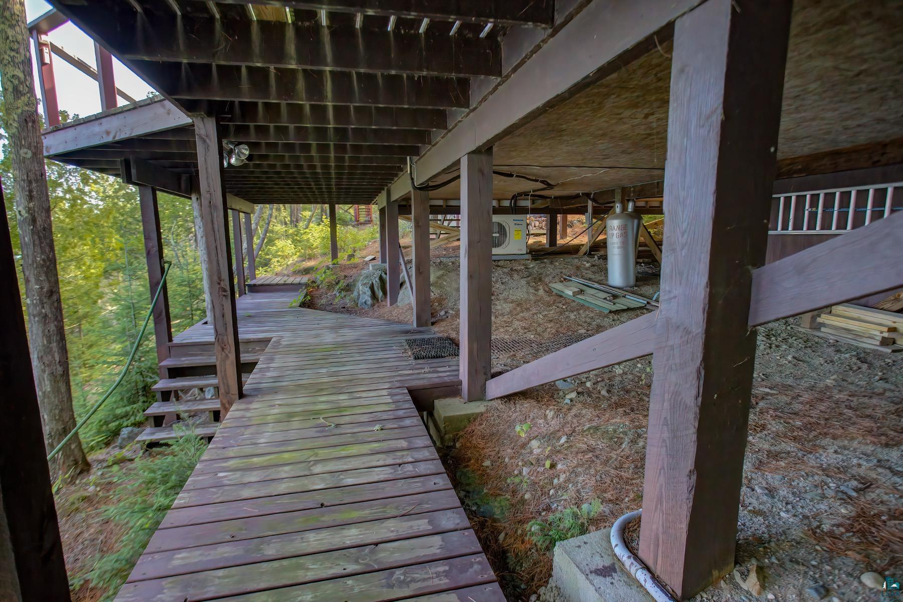 2811 Schaeffer Road Ely, MN 55731 - Photo 8 of 40 Expansive wood deck with stairs and a ramp, supported by sturdy timber posts