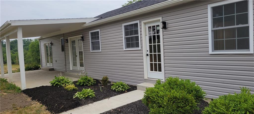 198 Little Summit Road Dunbar, PA 15431 - Photo 5 of 30 a front view of a house with a yard and potted plants