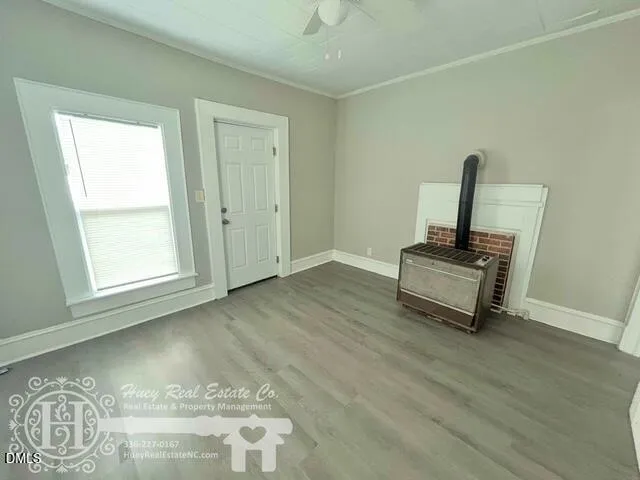 a view of a livingroom with wooden floor and a window