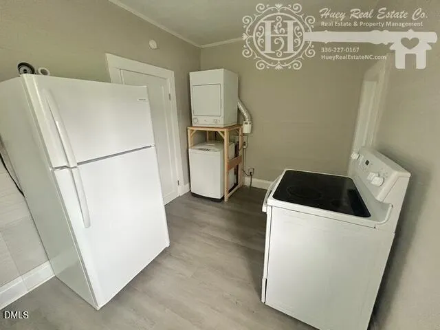 a white refrigerator freezer and a dishwasher with wooden floor