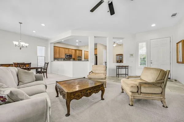 a living room with furniture and kitchen view