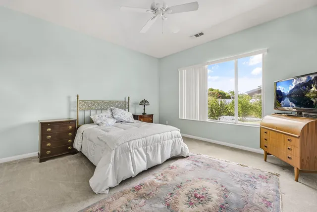 a bathroom with double vanity sinks a large mirror and a bathtub