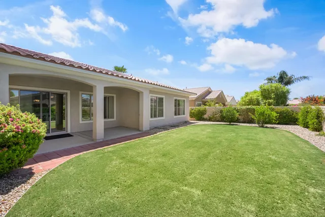 a view of green field with house in the background