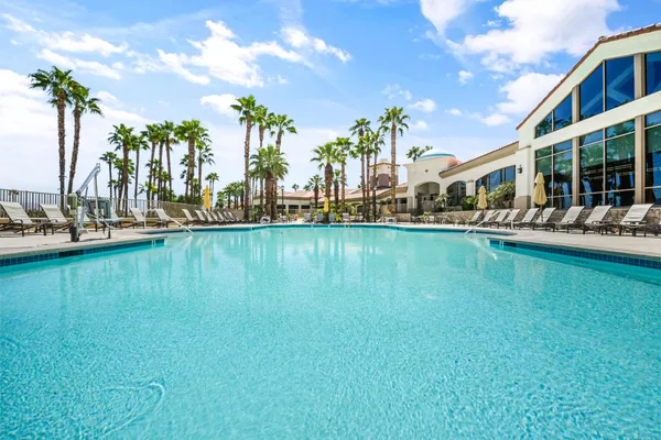 swimming pool view with a seating space and a garden view