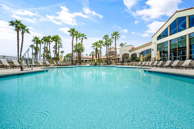 swimming pool view with a seating space and a garden view