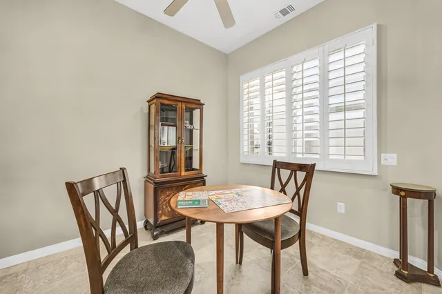 a view of a dining room with furniture and window