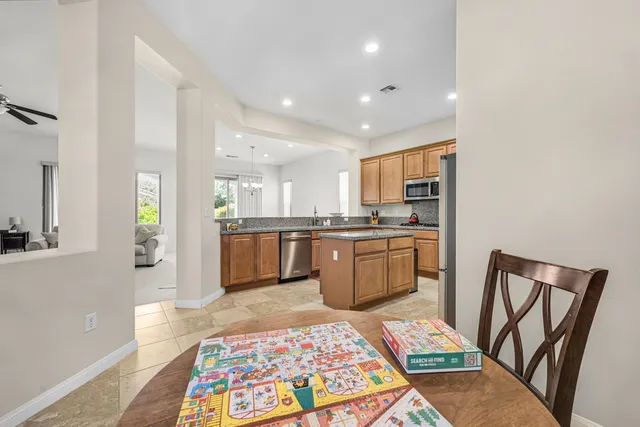a kitchen with stainless steel appliances granite countertop a refrigerator and a sink