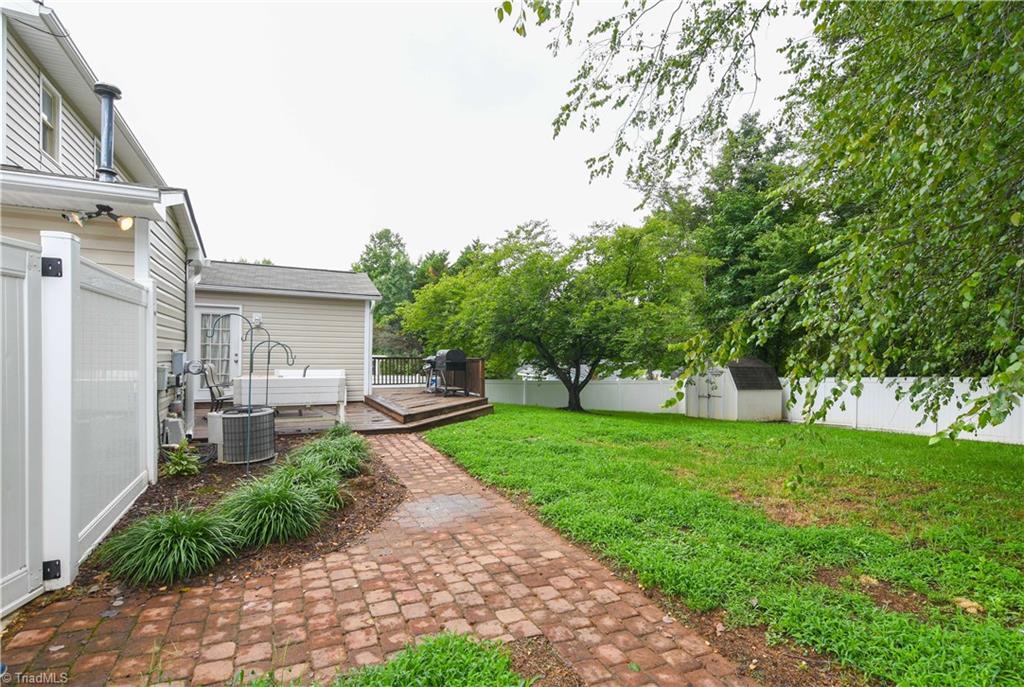 4105 Appleton Road Greensboro, NC 27405 - Photo 23 of 30 Fenced back yard offers deck, paver patio, and lots of room to entertain.