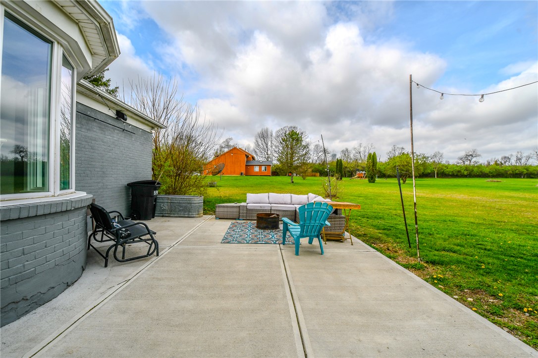 6169 Dayton Farmersville Road Dayton, OH 45417 - Photo 48 of 64 This expansive concrete patio overlooks a lush green landscape.
