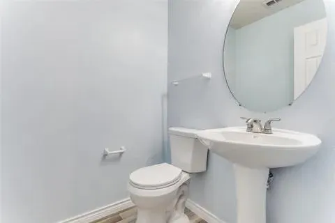 a bathroom with a sink a toilet and mirror