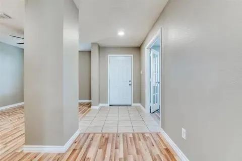 a view of a hallway with wooden floor