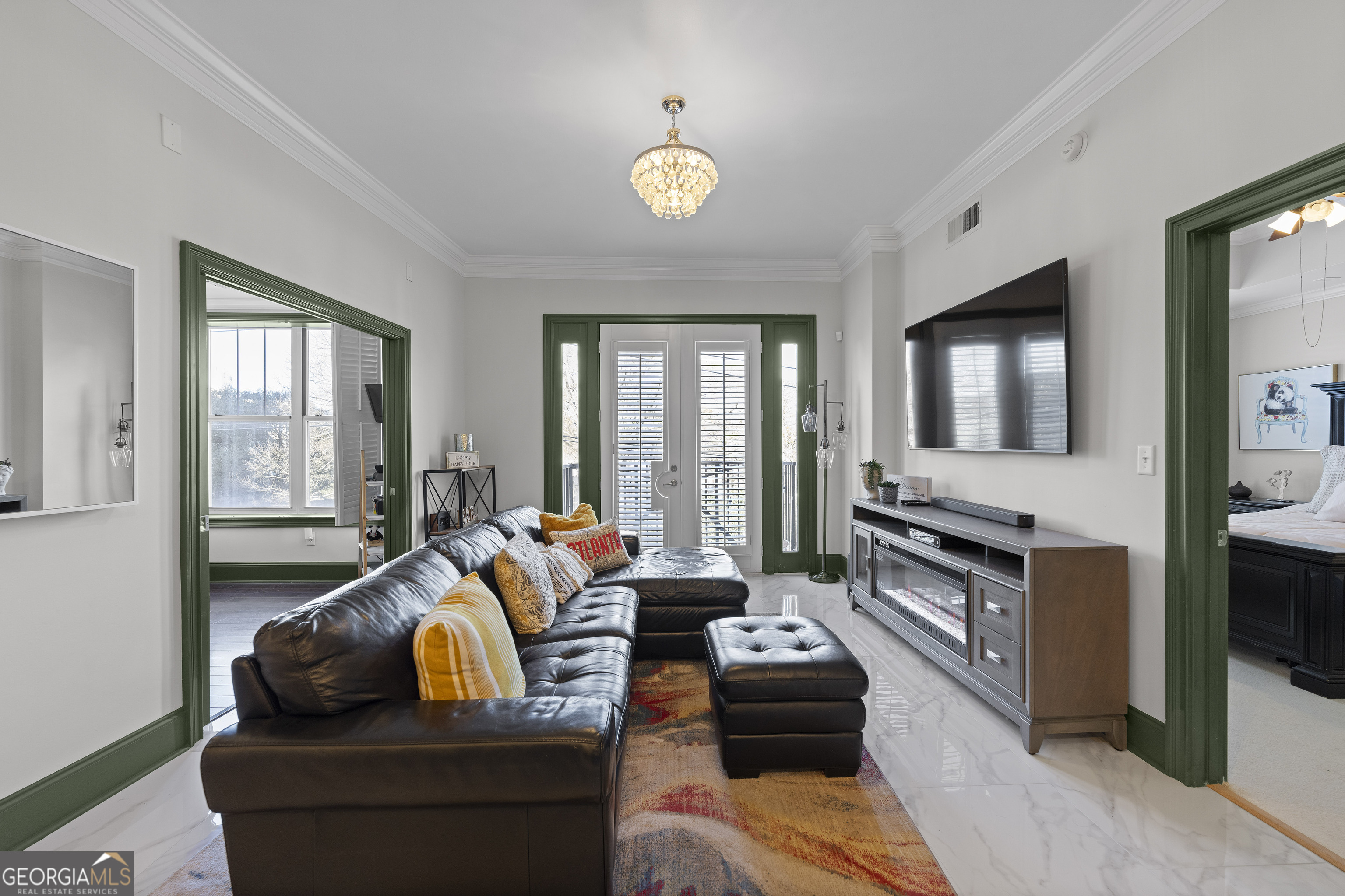2255 Peachtree Road Northeast, Unit 521 Atlanta, GA 30305 - Photo 16 of 51 a living room with furniture and a flat screen tv