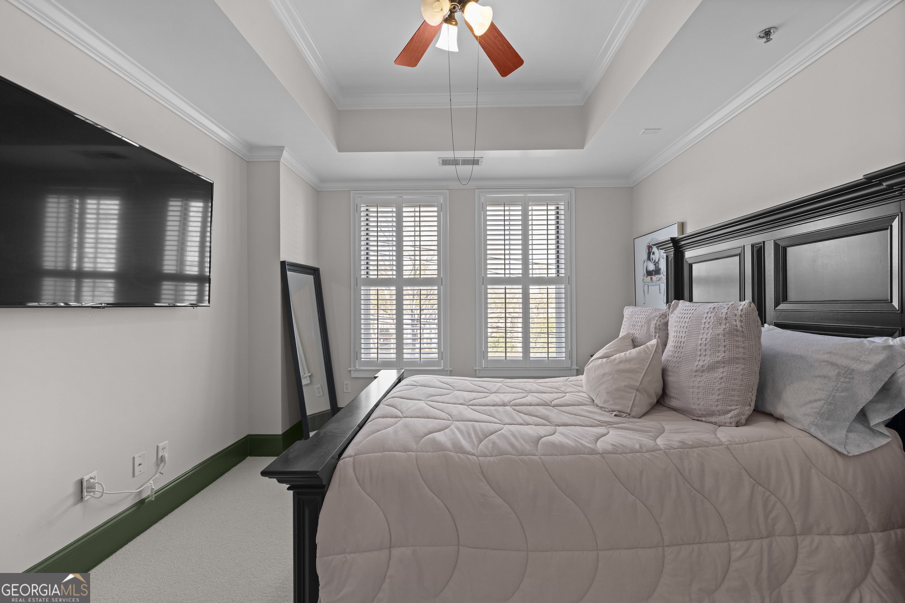 2255 Peachtree Road Northeast, Unit 521 Atlanta, GA 30305 - Photo 19 of 51 a bedroom with a large bed and a chandelier