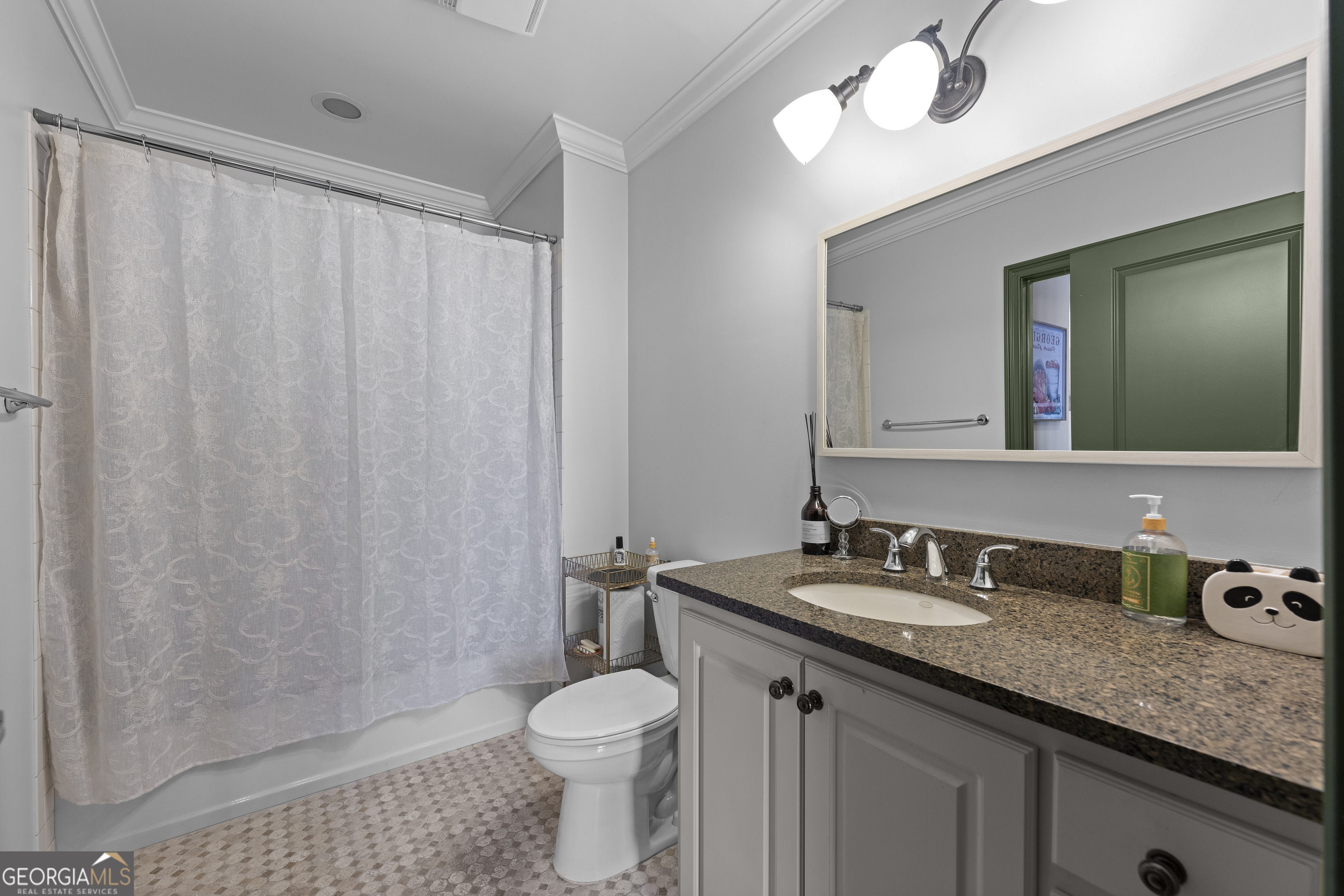 2255 Peachtree Road Northeast, Unit 521 Atlanta, GA 30305 - Photo 30 of 51 a bathroom with a granite countertop sink a toilet and a mirror