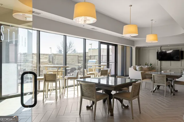 a view of a livingroom with furniture and floor to ceiling window