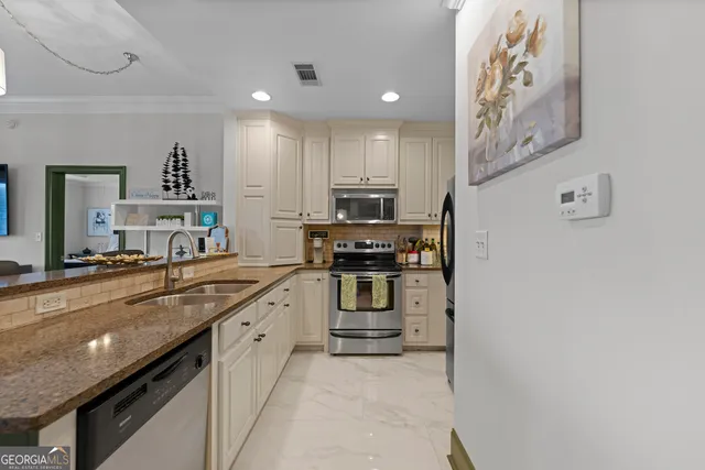 a kitchen with stainless steel appliances granite countertop a stove and a sink