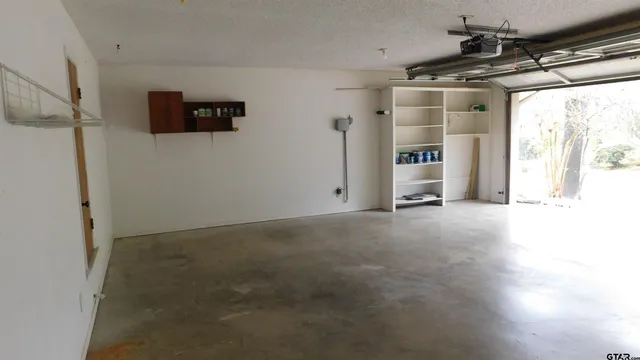 a view of a livingroom with a ceiling fan and window