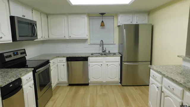 a kitchen with a refrigerator sink and microwave