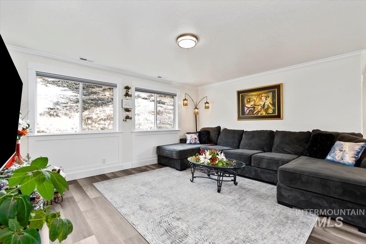 20530 North Shepherds Pie Way Boise, ID 83714 - Photo 19 of 47 Living room with light wood-style floors and ornamental molding