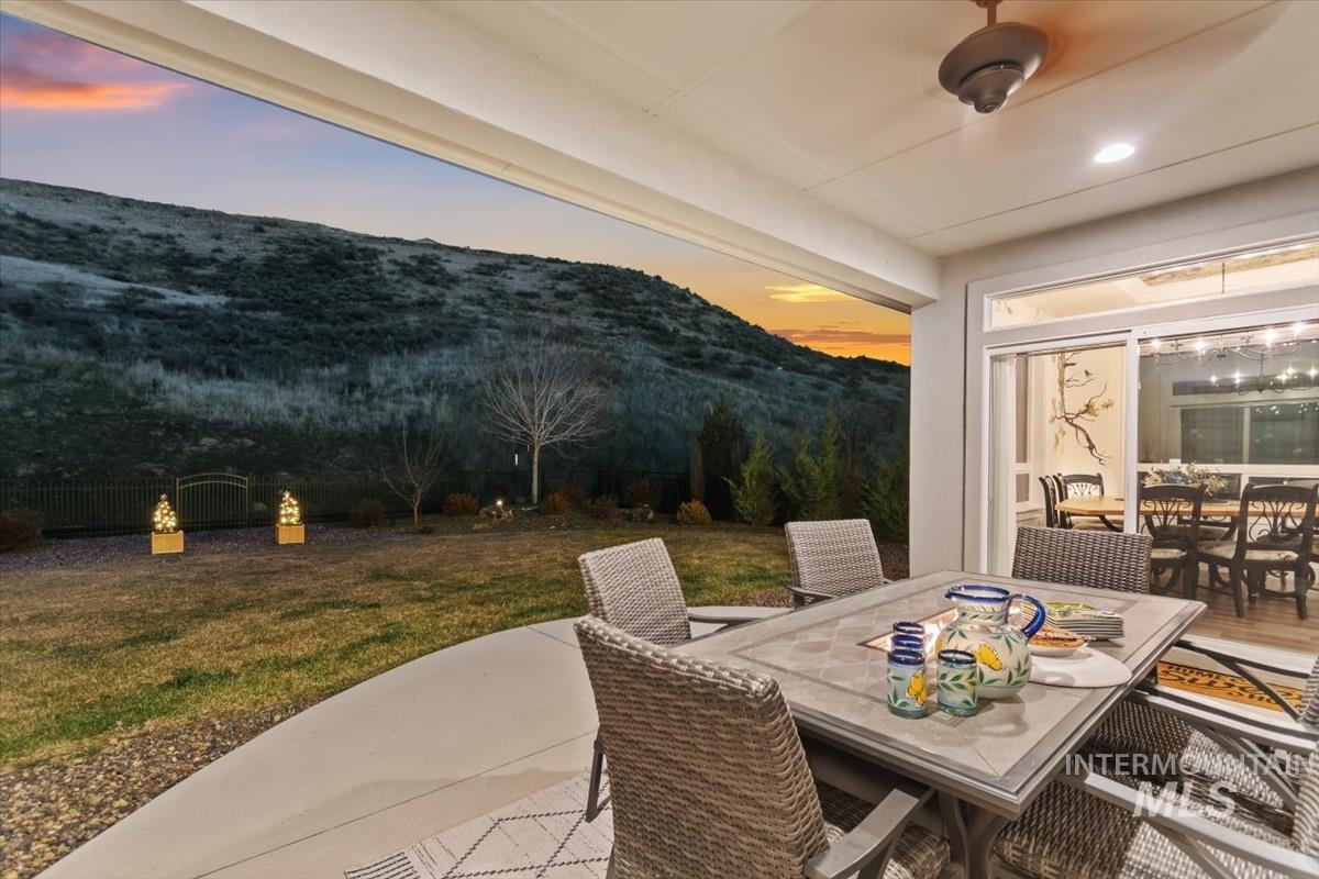 20530 North Shepherds Pie Way Boise, ID 83714 - Photo 30 of 47 Patio terrace at dusk with outdoor dining space, a patio, and a mountain view