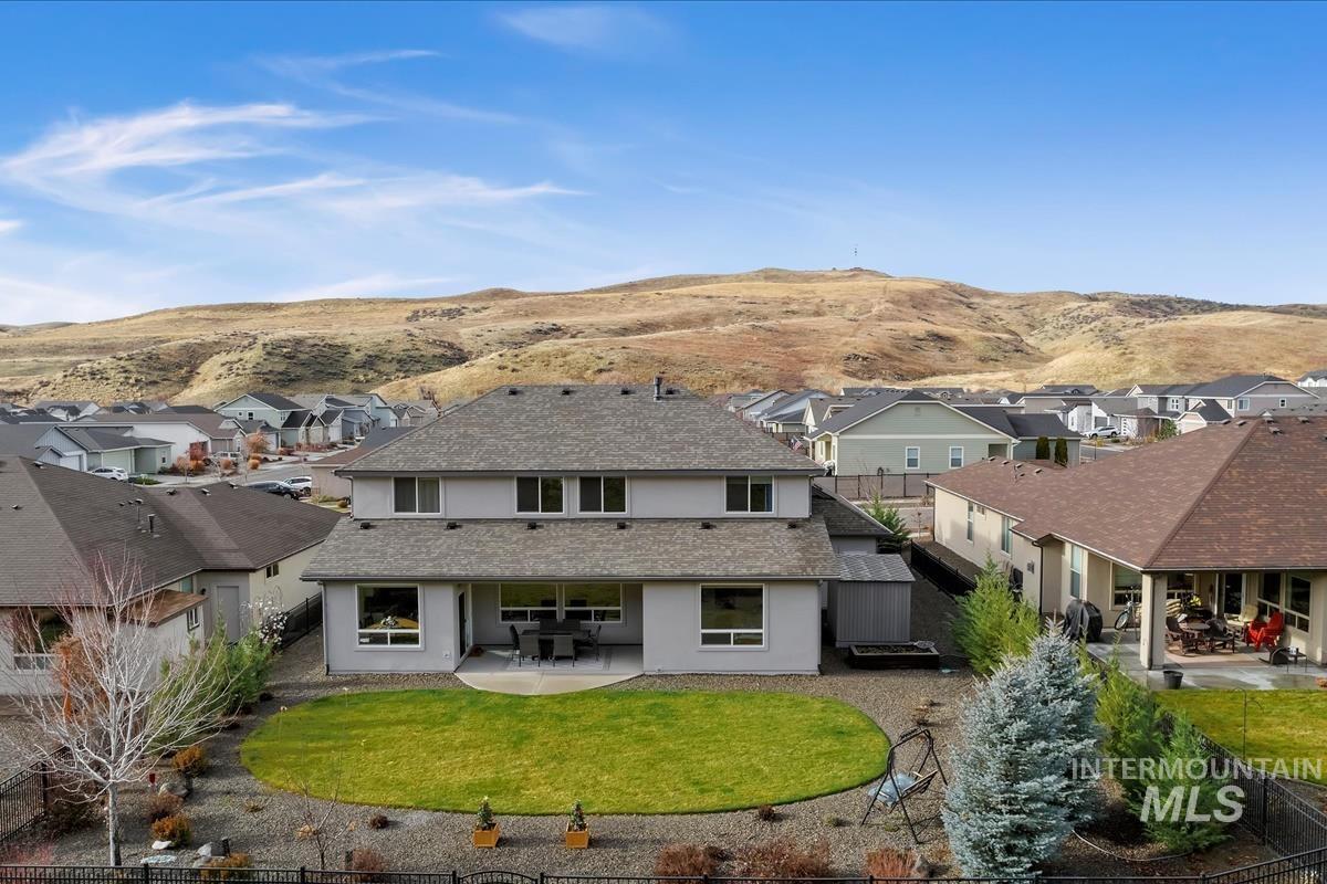 20530 North Shepherds Pie Way Boise, ID 83714 - Photo 36 of 47 Rear view of house with a patio area, a residential view, stucco siding, and a fenced backyard