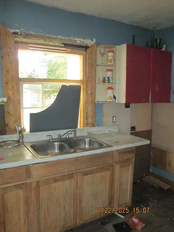 a kitchen with a sink and a window