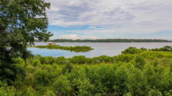 a view of a lake with houses in the back