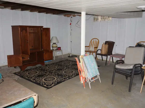 a bed room with a bed and a chair