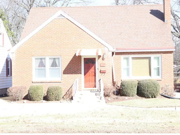 a view of a house with snow on the road