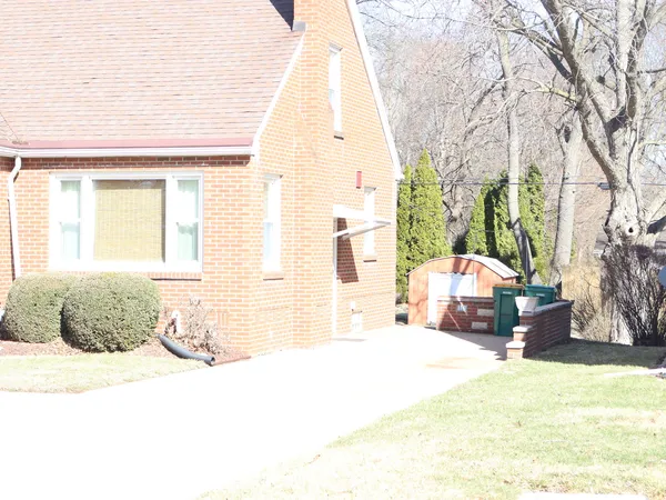a bedroom with a bed dresser and a large window