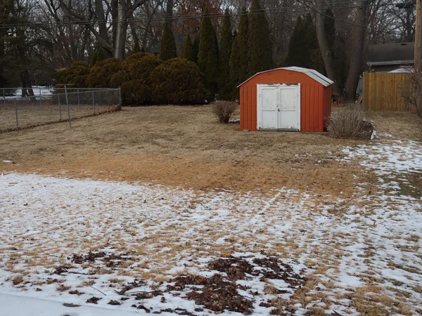 a view of a wooden house with a yard