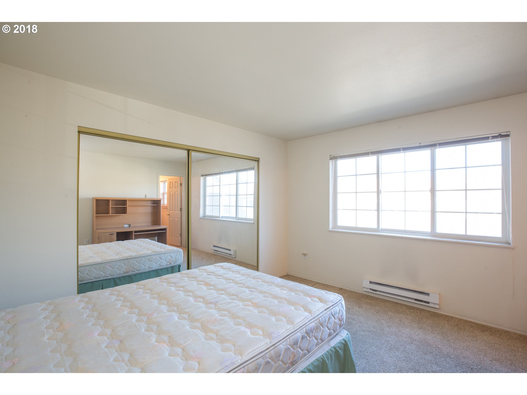 7123 Southwest Sagert Street, Unit 101 Tualatin, OR 97062 - Photo 11 of 24 a bedroom with a bed and a window